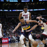 
              New Orleans Pelicans guard CJ McCollum (3) battles for a loose ball with Miami Heat guard Tyler Herro (14) in the first half of an NBA basketball game in New Orleans, Wednesday, Jan. 18, 2023. (AP Photo/Gerald Herbert)
            