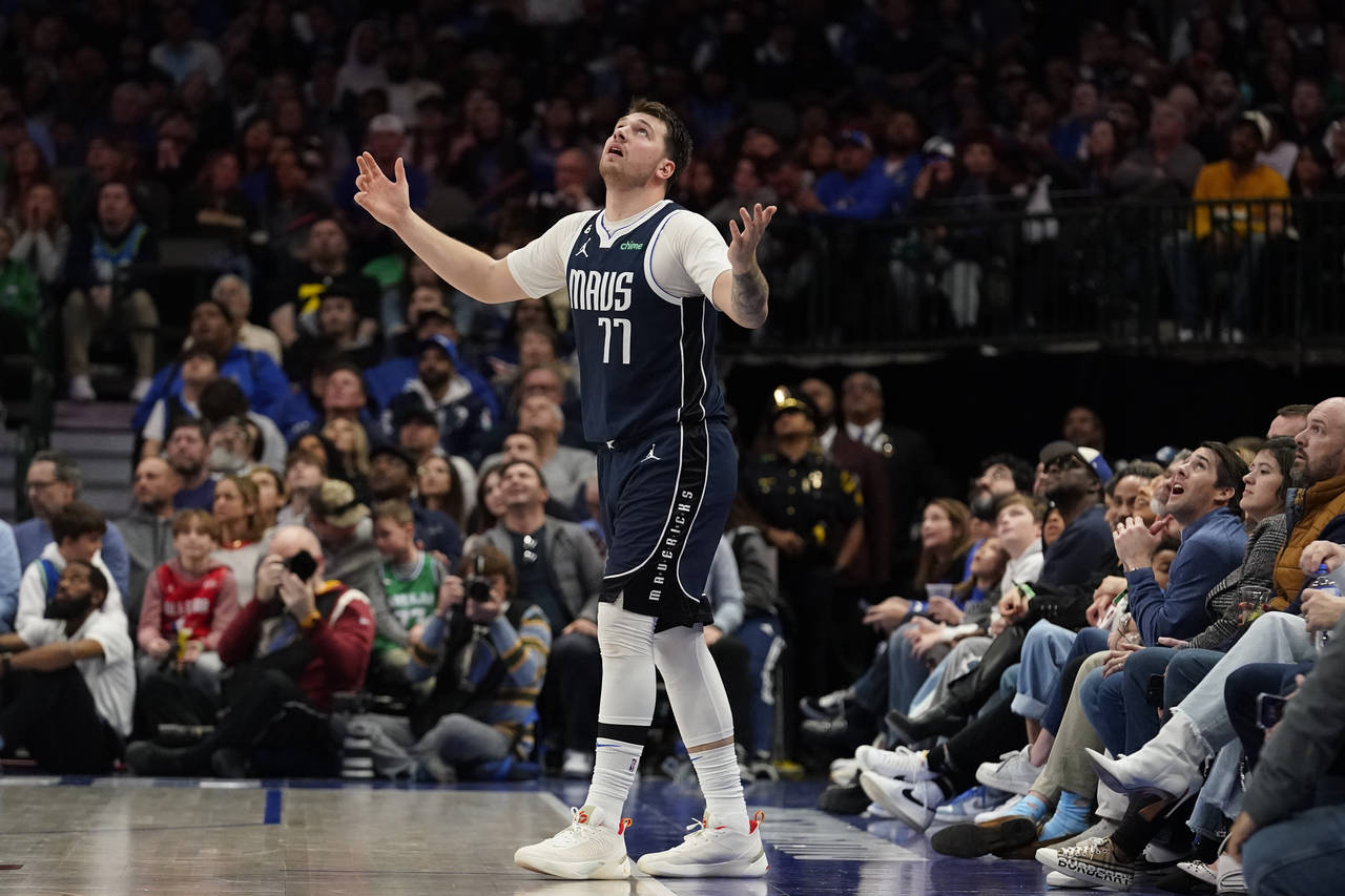 Dallas Mavericks guard Luka Doncic (77) reacts after watching a replay during the second half of an...