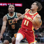 
              Atlanta Hawks guard Trae Young (11) is fouled by Charlotte Hornets guard Dennis Smith Jr. (8) during the first half of an NBA basketball game Saturday, Jan. 21, 2023, in Atlanta. (AP Photo/John Bazemore)
            