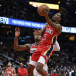 
              New Orleans Pelicans forward Herbert Jones (5) goes to the basket against Washington Wizards forward Rui Hachimura for a layup during the second quarter of an NBA basketball game, Monday, Jan. 9, 2023, in Washington. (AP Photo/Terrance Williams)
            