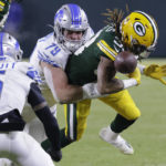 
              Green Bay Packers running back Aaron Jones fumbles as he is hit by Detroit Lions defensive end John Cominsky (79) during the first half of an NFL football game Sunday, Jan. 8, 2023, in Green Bay, Wis. The Lions recovered the fumble. (AP Photo/Mike Roemer)
            
