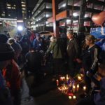 
              Attendees holds hands and pray during a prayer vigil for Buffalo Bills' Damar Hamlin outside of the University of Cincinnati Medical Center, Tuesday, Jan. 3, 2023, in Cincinnati. Hamlin was taken to the hospital after collapsing on the field during an NFL football game against the Cincinnati Bengals on Monday night.(AP Photo/Darron Cummings)
            