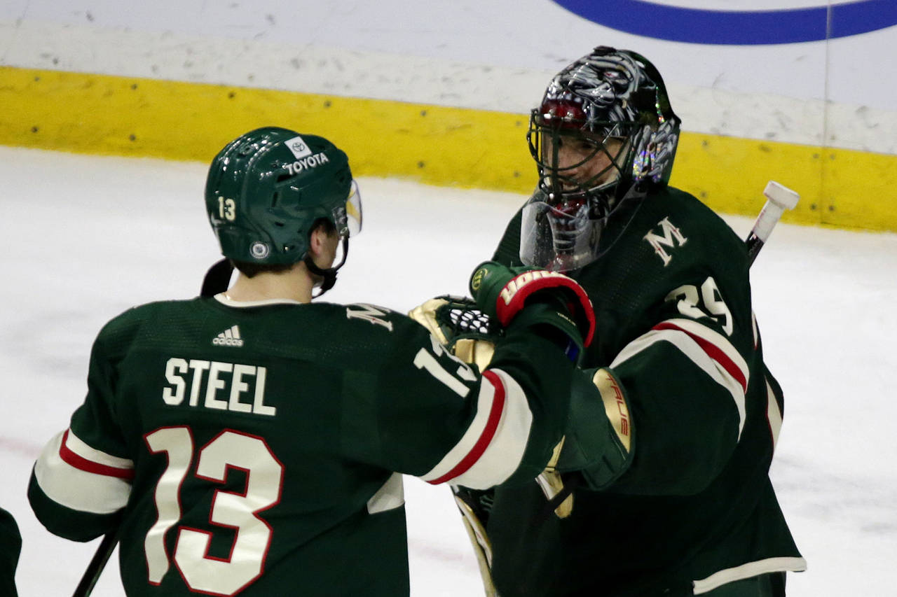 Minnesota Wild goaltender Marc-Andre Fleury (29) is congratulated by teammate Sam Steel (13) after ...