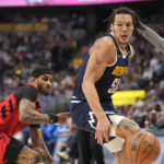 
              Denver Nuggets forward Aaron Gordon, right, and Portland Trail Blazers guard Gary Payton II watch the ball get away during the second half of an NBA basketball game Tuesday, Jan. 17, 2023, in Denver. (AP Photo/David Zalubowski)
            