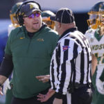 
              CORRECTS TO NORTH DAKOTA STATE NOT NORTH DAKOTA - North Dakota State head coach Matt Entz, left, speaks to an official during the first half of the FCS Championship NCAA college football game against the South Dakota State, Sunday, Jan. 8, 2023, in Frisco, Texas. (AP Photo/LM Otero)
            