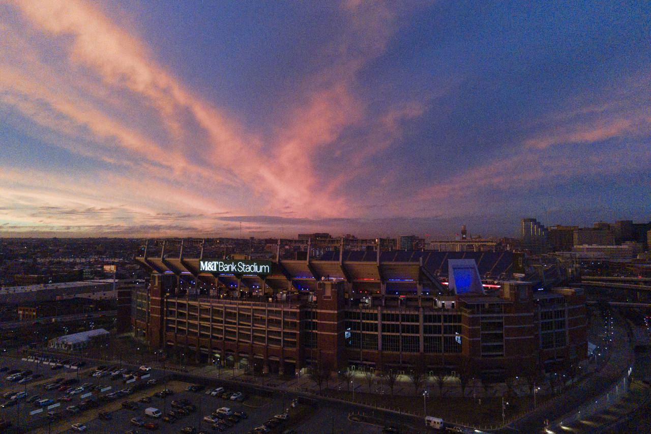 Clouds are lit up with the sunset light over M&T Bank, the home stadium of the Baltimore Ravens, do...