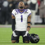 
              TCU wide receiver Quentin Johnston (1) prays before the national championship NCAA College Football Playoff game against Georgia, Monday, Jan. 9, 2023, in Inglewood, Calif. (AP Photo/Marcio Jose Sanchez)
            