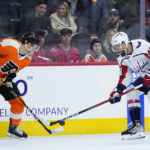 
              Philadelphia Flyers' Nick Seeler (24) and Washington Capitals' Tom Wilson (43) battle for the puck during the first period of an NHL hockey game, Wednesday, Jan. 11, 2023, in Philadelphia. (AP Photo/Matt Slocum)
            