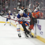 
              Edmonton Oilers' Vincent Desharnais (73) chases the puck after shoving Anaheim Ducks' Brett Leason (20) into the bench during the first period of an NHL hockey game Wednesday, Jan. 11, 2023, in Anaheim, Calif. (AP Photo/Jae C. Hong)
            