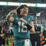 
              Jacksonville Jaguars quarterback Trevor Lawrence (16) celebrates after defeating the Tennessee Titans in an NFL football game, Saturday, Jan. 7, 2023, in Jacksonville, Fla. The Jaguars won 20-16. (AP Photo/John Raoux)
            