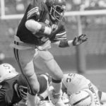 
              FILE - Southern California tailback Charles White (12) carries for a first down against Stanford during an NCAA college football game in Los Angeles, Oct. 13, 1979. White died Wednesday, Jan. 11, 2023. He was 64. USC announced the death of White, who is still the Trojans' career rushing leader with 6,245 yards. The nine-year NFL veteran died of cancer, the school said.  (AP Photo, File)
            