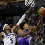 
              Utah Jazz guard Collin Sexton (2) shoots in front of Minnesota Timberwolves forward Jaden McDaniels (3) in the first quarter of an NBA basketball game, Monday, Jan. 16, 2023, in Minneapolis. (AP Photo/Andy Clayton-King)
            