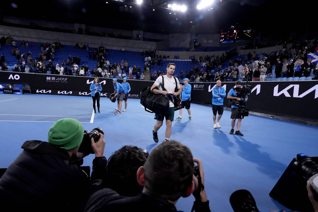 Andy Murray of Britain leaves Margaret Court Arena in the early hours of Friday Jan. 20, 2023 follo...