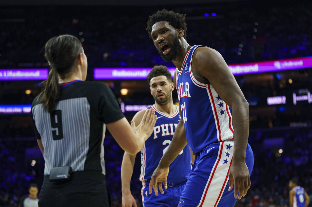 Philadelphia 76ers' Joel Embiid, right, argues the foul called against him by referee Natalie Sago,...