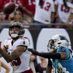 
              Tampa Bay Buccaneers wide receiver Mike Evans scores in front of Carolina Panthers cornerback CJ Henderson during the second half of an NFL football game between the Carolina Panthers and the Tampa Bay Buccaneers on Sunday, Jan. 1, 2023, in Tampa, Fla. (AP Photo/Chris O'Meara)
            