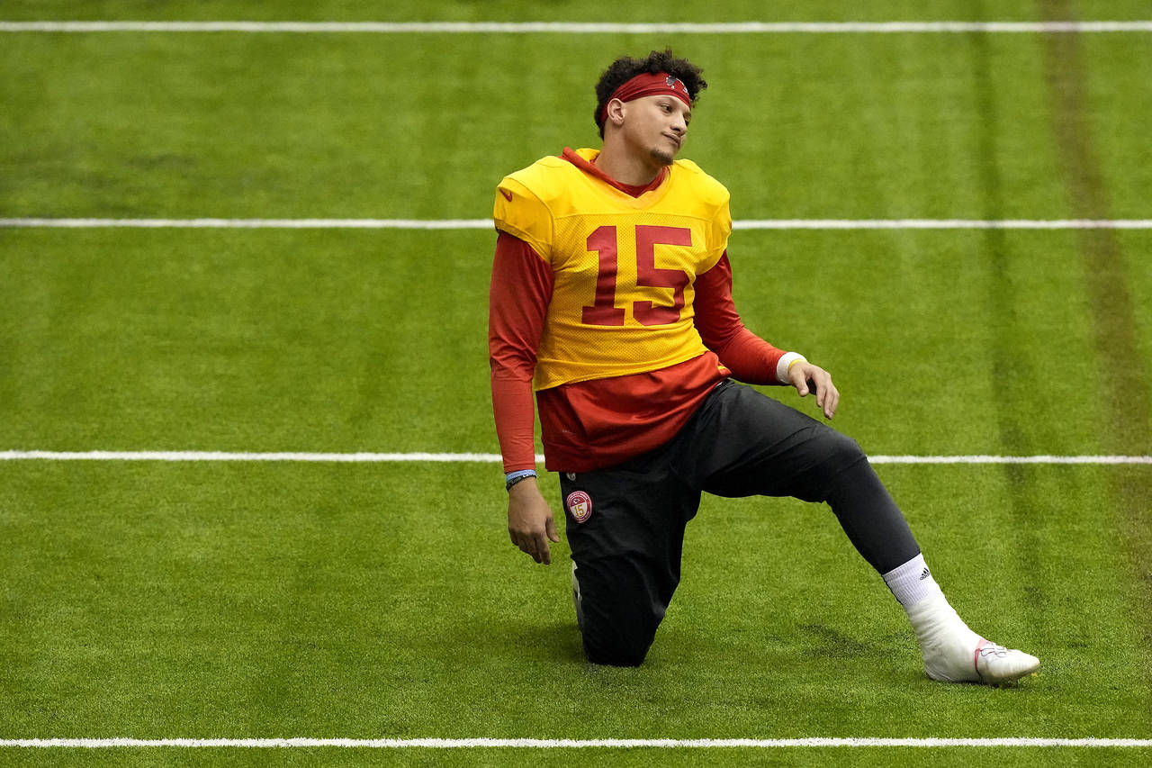 Kansas City Chiefs quarterback Patrick Mahomes stretches during an NFL football workout Wednesday, ...