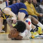 
              Golden State Warriors guard Ty Jerome, top, reaches for the ball over Detroit Pistons forward Saddiq Bey during the first half of an NBA basketball game in San Francisco, Wednesday, Jan. 4, 2023. (AP Photo/Jeff Chiu)
            