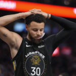 
              Golden State Warriors guard Stephen Curry reacts during the second half of the team's NBA basketball game against the Phoenix Suns in San Francisco, Tuesday, Jan. 10, 2023. (AP Photo/Godofredo A. Vásquez)
            
