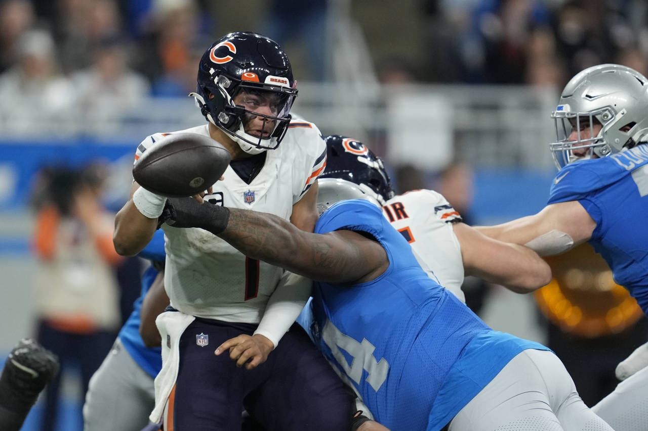 Chicago Bears quarterback Justin Fields (1) is sacked during the second half of an NFL football gam...