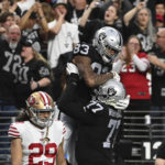
              Las Vegas Raiders tight end Darren Waller (83) is congratulated by teammates after a 24-yard touchdown pass during the first half of an NFL football game between the San Francisco 49ers and Las Vegas Raiders, Sunday, Jan. 1, 2023, in Las Vegas. (AP Photo/David Becker)
            