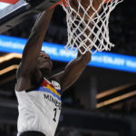 
              Minnesota Timberwolves guard Anthony Edwards (1) dunks during the second half of an NBA basketball game against the Phoenix Suns, Friday, Jan. 13, 2023, in Minneapolis. (AP Photo/Abbie Parr)
            