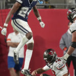 
              Dallas Cowboys safety Israel Mukuamu (24) celebrates the sacking of Tampa Bay Buccaneers quarterback Tom Brady (12) during the second half of an NFL wild-card football game, Monday, Jan. 16, 2023, in Tampa, Fla. (AP Photo/John Raoux)
            