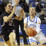 
              Kentucky's Jada Walker, right, looks for a shot while guarded by South Carolina's Mar'shaun Bostic (12) during the first half of an NCAA college basketball game in Lexington, Ky., Thursday, Jan. 12, 2023. (AP Photo/James Crisp)
            