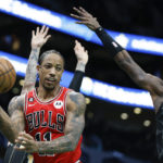 
              Chicago Bulls forward DeMar DeRozan (11) looks to pass the ball around Charlotte Hornets guard Terry Rozier (3) during the first half of an NBA basketball game in Charlotte, N.C., Thursday, Jan. 26, 2023. (AP Photo/Nell Redmond)
            