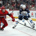 
              Detroit Red Wings left wing Lucas Raymond (23) and Winnipeg Jets defenseman Brenden Dillon (5) battle for the puck in the second period of an NHL hockey game Tuesday, Jan. 10, 2023, in Detroit. (AP Photo/Paul Sancya)
            