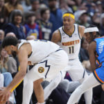 
              Denver Nuggets guard Jamal Murray, front left, saves an in-bound pass from forward Bruce Brown (11) as Oklahoma City Thunder guard Shai Gilgeous-Alexander (2) defends in the second half of an NBA basketball game Sunday, Jan. 22, 2023, in Denver. (AP Photo/David Zalubowski)
            