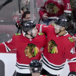 
              Chicago Blackhawks' Isaak Phillips (41) celebrates his first career NHL goal with Tyler Johnson during the second period of a hockey game against the Seattle Kraken, Saturday, Jan. 14, 2023, in Chicago. (AP Photo/Charles Rex Arbogast)
            
