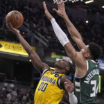
              Indiana Pacers' Bennedict Mathurin (00) puts up a shot against Milwaukee Bucks' Giannis Antetokounmpo (34) during the first half of an NBA basketball game, Friday, Jan. 27, 2023, in Indianapolis. (AP Photo/Darron Cummings)
            