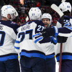 
              Winnipeg Jets' Nikolaj Ehlers (27) celebrates his first-period goal with teammates, from left to right, Pierre-Luc Dubois (80), Josh Morrissey (44) and Mark Scheifele (55) while taking on the Ottawa Senators during NHL hockey game action in Ottawa, Ontario, Saturday, Jan. 21, 2023. (Sean Kilpatrick/The Canadian Press via AP)
            