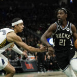 
              Milwaukee Bucks' Jrue Holiday (21) drives to the basket against Indiana Pacers' Andrew Nembhard during the second half of an NBA basketball game Monday, Jan. 16, 2023, in Milwaukee. (AP Photo/Aaron Gash)
            
