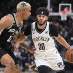 
              Brooklyn Nets' Seth Curry (30) drives against San Antonio Spurs' Jeremy Sochan during the first half of an NBA basketball game Tuesday, Jan. 17, 2023, in San Antonio. (AP Photo/Darren Abate)
            