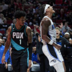 
              Orlando Magic forward Paolo Banchero, right, reacts next to Portland Trail Blazers guard Anfernee Simons after scoring during the first half of an NBA basketball game in Portland, Ore., Tuesday, Jan. 10, 2023. (AP Photo/Craig Mitchelldyer)
            