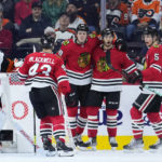 
              Chicago Blackhawks' Connor Murphy (5), Reese Johnson (52), MacKenzie Entwistle (58) and Colin Blackwell (43) celebrate past Philadelphia Flyers' Carter Hart (79) after a goal by Johnson during the second period of an NHL hockey game, Thursday, Jan. 19, 2023, in Philadelphia. (AP Photo/Matt Slocum)
            