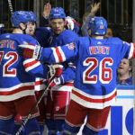 
              New York Rangers defenseman K'Andre Miller, center, celebrates after scoring against the Minnesota Wild during the second period of an NHL hockey game, Tuesday, Jan. 10, 2023, at Madison Square Garden in New York. (AP Photo/Mary Altaffer)
            