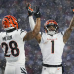 
              Cincinnati Bengals wide receiver Ja'Marr Chase (1) and Cincinnati Bengals running back Joe Mixon (28) motion for a touchdown against the Buffalo Bills during the third quarter of an NFL division round football game, Sunday, Jan. 22, 2023, in Orchard Park, N.Y. (AP Photo/Joshua Bessex)
            