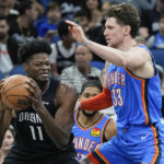 
              Orlando Magic's Mo Bamba (11) goes to the basket against Oklahoma City Thunder's Mike Muscala (33) during the first half of an NBA basketball game Wednesday, Jan. 4, 2023, in Orlando, Fla. (AP Photo/John Raoux)
            