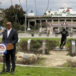 
              California Assemblymember Chris Holden discusses a bill called the College Athlete Protection Act in front of the Rose Bowl on Thursday, Jan. 19, 2023, in Pasadena, Calif. The bill would require schools that play major college sports to pay some athletes as much as $25,000 annually, along with covering the cost of six-year guaranteed athletic scholarships and post-college medical expenses. (AP Photo/Beth Harris)
            