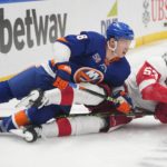 
              New York Islanders' Anthony Beauvillier (18) and Detroit Red Wings' Moritz Seider (53) fall down while fighting for postion during the second period of an NHL hockey game Friday, Jan. 27, 2023, in Elmont, N.Y. (AP Photo/Frank Franklin II)
            