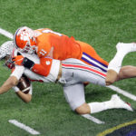 NEW ORLEANS, LOUISIANA - JANUARY 01: Justin Fields #1 of the Ohio State Buckeyes is tackled by Bryan Bresee #11 of the Clemson Tigers in the first half against the Clemson Tigers during the College Football Playoff semifinal game at the Allstate Sugar Bowl at Mercedes-Benz Superdome on January 01, 2021 in New Orleans, Louisiana. (Photo by Sean Gardner/Getty Images)