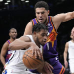 
              Brooklyn Nets guard Cam Thomas drives against Phoenix Suns guard Devin Booker (1) during the first half of an NBA basketball game, Tuesday, Feb. 7, 2023, in New York. (AP Photo/Mary Altaffer)
            
