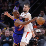 
              Phoenix Suns' Chris Paul, left, collides with Los Angeles Clippers' Ivica Zubac as he passes the ball during the first half of an NBA basketball game Thursday, Feb. 16, 2023, in Phoenix. (AP Photo/Darryl Webb)
            