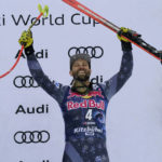 
              Third place United States' Travis Ganong celebrates on the podium after an alpine ski, men's World Cup downhill race in Kitzbuehel, Austria, Saturday, Jan. 21, 2023. (AP Photo/Giovanni Auletta)
            