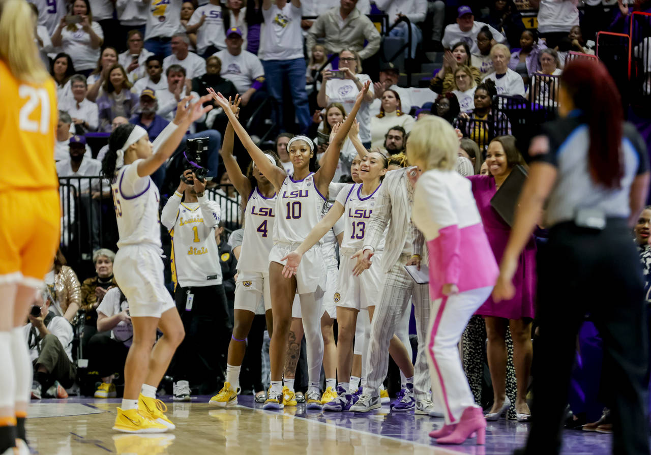LSU forward Angel Reese (10) celebrates with teammates after a win as time expires in the second ha...