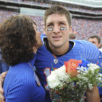 
              FILE - Florida quarterback Tim Tebow embraces his mother, Pam, during a pregame ceremony for graduating seniors on the Florida football team prior to an NCAA college football game against Florida State in Gainesville, Fla., Nov. 28, 2009. While its Super Bowl commercial appearances are few, religion – Christianity especially – is entrenched in football culture.(AP Photo/Phil Sandlin, Pool, File)
            