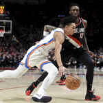 
              Oklahoma City Thunder guard Tre Mann, front, drives to the basket on Portland Trail Blazers forward Nassir Little during the first half of an NBA basketball game in Portland, Ore., Friday, Feb. 10, 2023. (AP Photo/Steve Dykes)
            