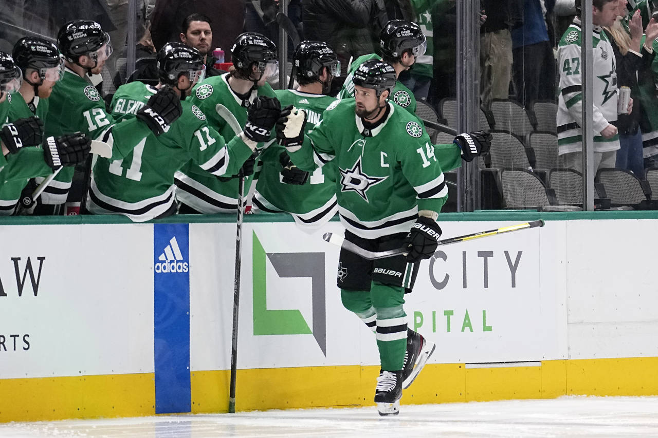 Dallas Stars left wing Jamie Benn (14) is congratulated after scoring during the second period of t...